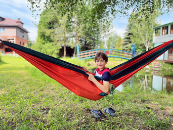 Rear view of woman swinging in park