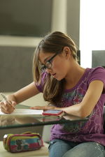 Girl doing homework at table