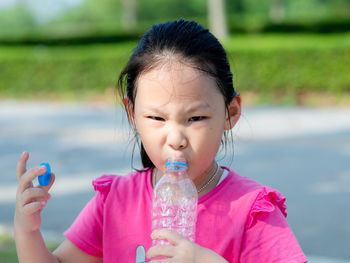 Portrait of cute girl drinking water