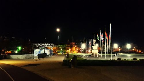 View of illuminated empty road at night