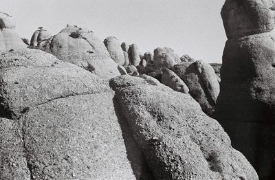 Low angle view of rock formation against sky