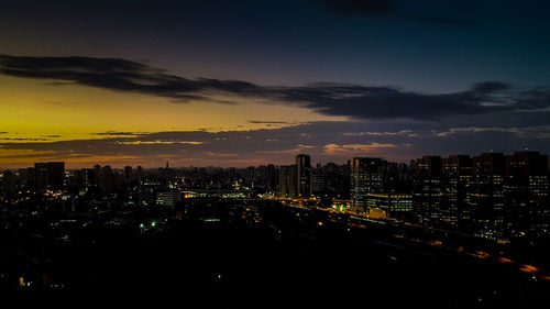 Aerial view of city lit up at night