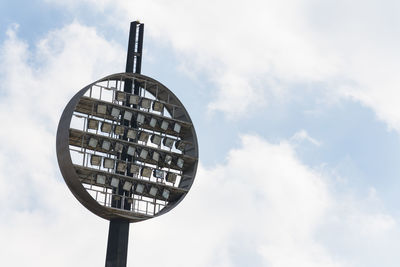 Low angle view of floodlights against sky