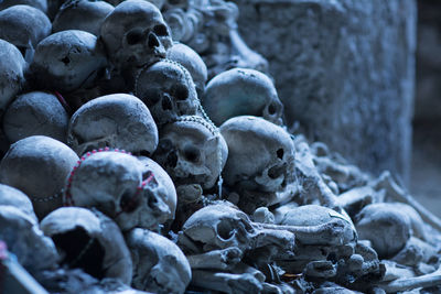 Rosary beads on human skulls and bones in cave