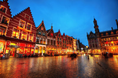 Reflection of buildings in city at night