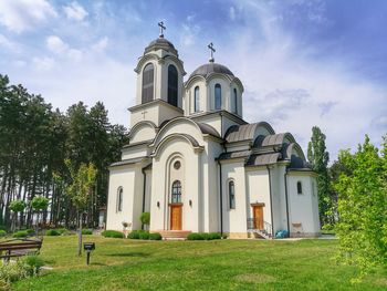 Church by building against sky