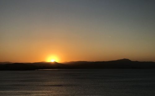 Scenic view of silhouette mountains against sky during sunset
