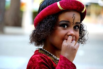 Close-up portrait of young woman wearing hat