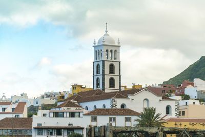 View of buildings in town against sky