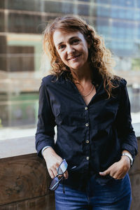 Portrait of young woman standing at home