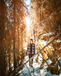 Man walking at forest during winter