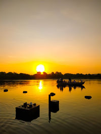 Scenic view of lake against sky during sunset