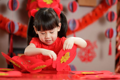 Young chinese girl making traditional chinese lantern for celerating chinese new year