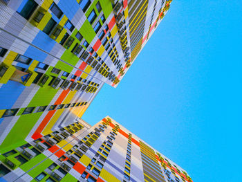 Low angle view of modern buildings against clear blue sky