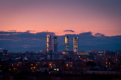 Illuminated factory against sky at night