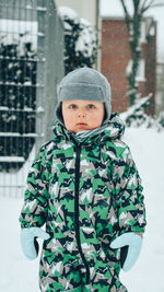 Portrait of boy standing in snow