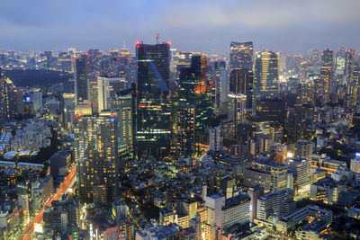 High angle view of illuminated city buildings against sky