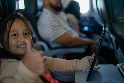 Close-up of cute girl sitting in any aeroplane.