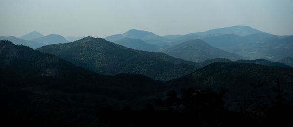 Scenic view of mountains against sky at dusk