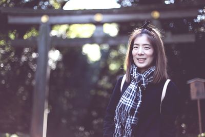 Portrait of smiling young woman standing outdoors