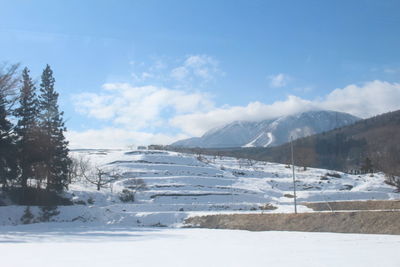 Scenic view of landscape against sky during winter