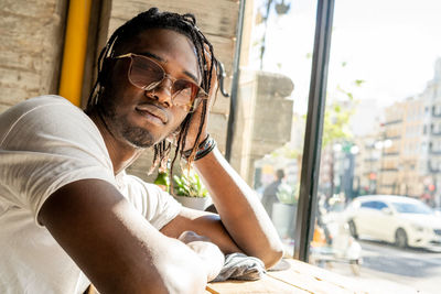 Portrait of man in sunglasses at cafe