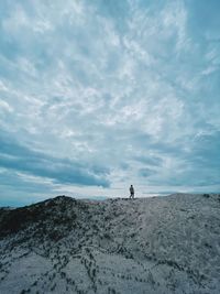 Man standing on land against sky