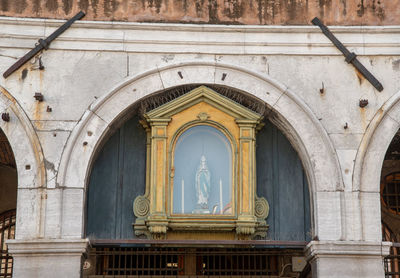 Ancient building exterior with religious statue, venice, italy