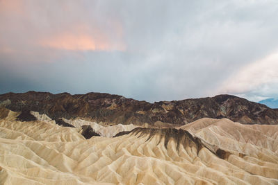 Scenic view of mountain against cloudy sky