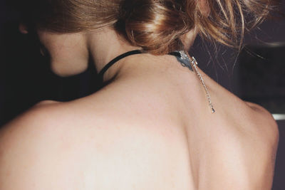 Rear view of woman wearing necklace