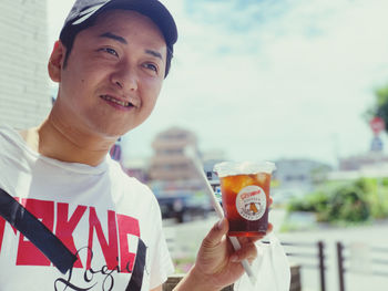 Portrait of smiling man holding drink