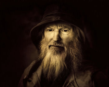 Portrait of man wearing mask against black background