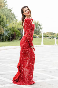 Portrait of beautiful young woman standing outdoors