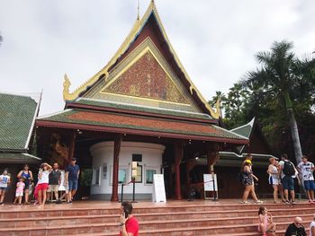 People at temple against sky