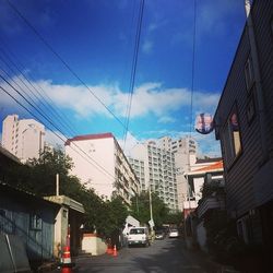Buildings in city against cloudy sky