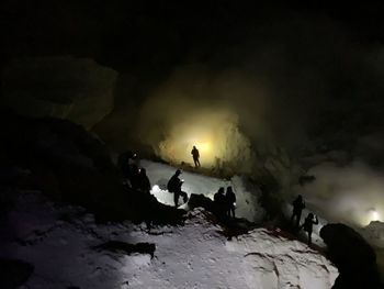 People on rocks in cave