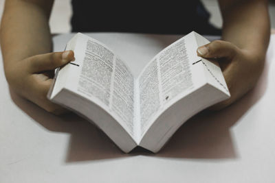 Midsection of woman reading book