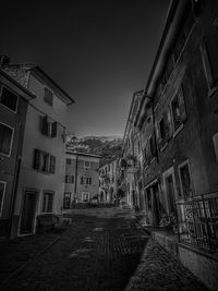 Narrow alley amidst buildings against sky