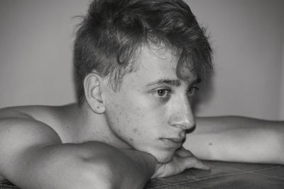 Close-up portrait of shirtless boy at home