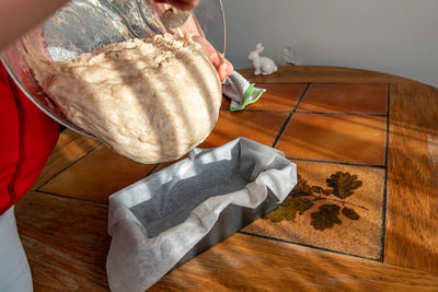 High angle view of man holding ice cream on table