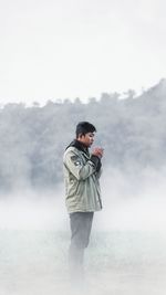 Full length of young man standing on mountain