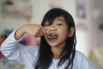 Portrait of cute girl holding camera