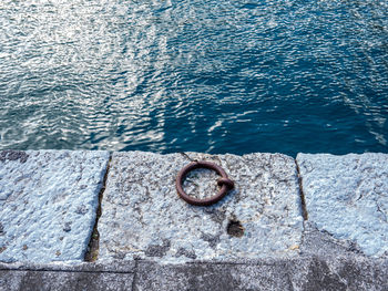 High angle view of rusty metal on sea shore