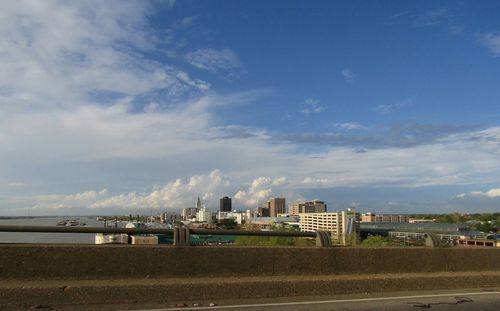 Buildings in city against blue sky