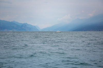 Scenic view of sea against sky with a speedboat at lake garda italy