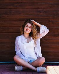 Portrait of young woman sitting outdoors