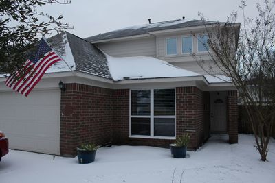 Houses and trees by building during winter