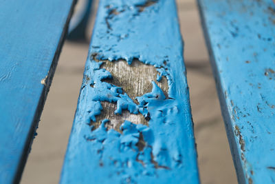 Close-up of wood with blue peeling paint