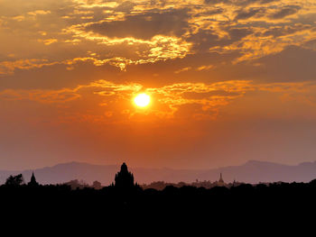 Silhouette landscape against sky during sunset