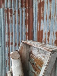 Close-up of old rusty metallic structure against wall